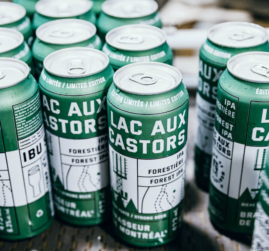 Group of green “Lac aux Castors IPA” beer cans arranged together